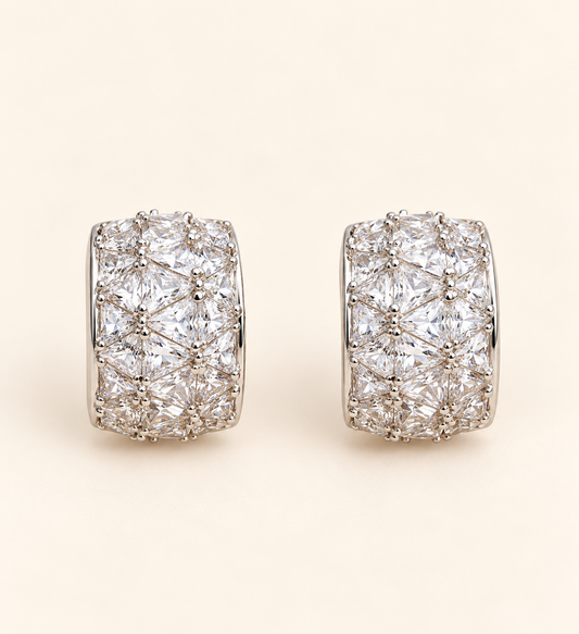 Milan Crystal Huggie Earrings with multi-cut crystals on soft ivory cream background