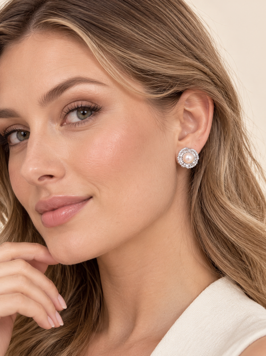 Model wearing Serena Pearl Halo Earrings with double crystal halo