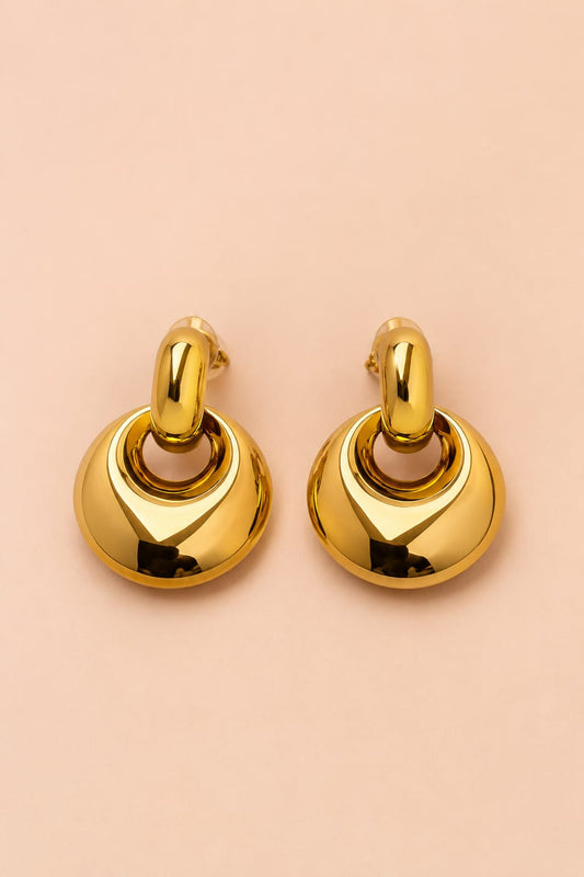 Front view of Valoria London Aurelia sculpted gold drop earrings with polished interlocking circular design