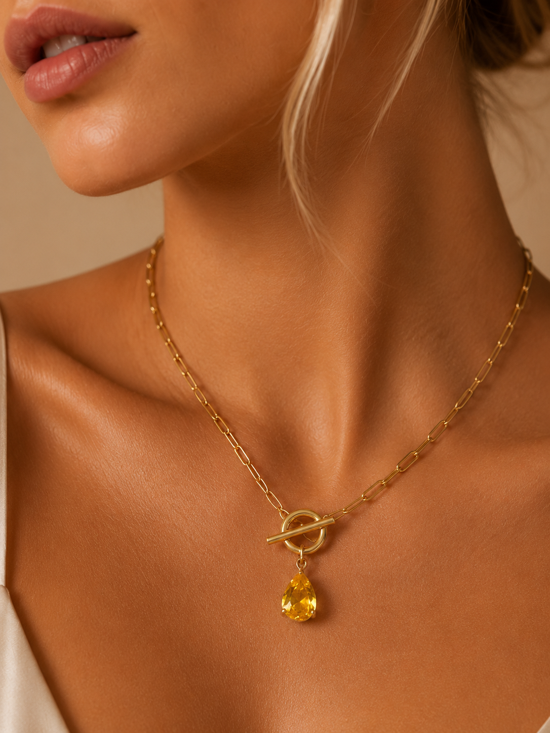 Valoria London Golden Radiance gold paperclip chain necklace with pear-cut golden crystal pendant and signature toggle clasp.