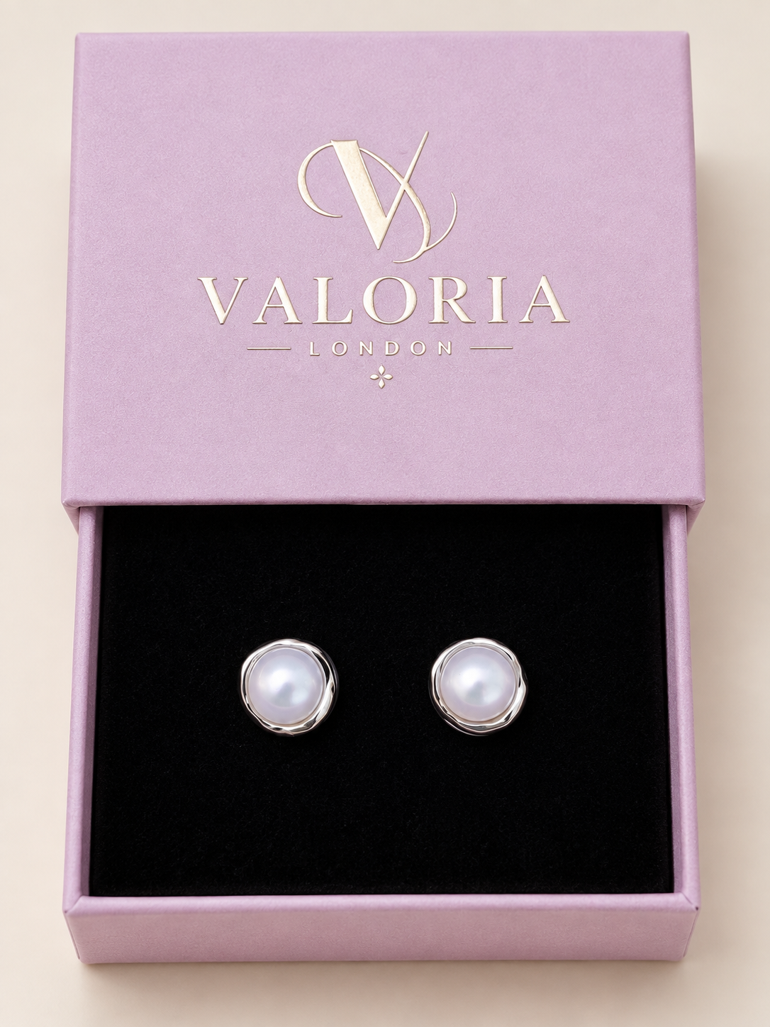 Pearl Glow Sterling Silver Stud Earrings with luminous white pearl centres in polished silver settings, presented in a Valoria London jewellery box.
