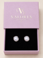 Pearl Glow Sterling Silver Stud Earrings with luminous white pearl centres in polished silver settings, presented in a Valoria London jewellery box.