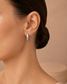 Model wearing Amélie crystal channel hoop earrings by Valoria London