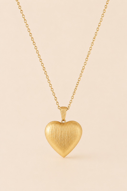 Amora textured gold heart pendant necklace on soft ivory cream background