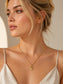 Model wearing the Amorette gemstone heart toggle necklace by Valoria London