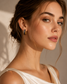 Model wearing brown marbled gold-tone sculpted hoop earrings