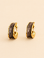 Brown marbled gold-tone sculpted hoop earrings on soft ivory cream background