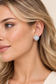 UK model wearing Daisy Pearl Bloom Earrings with pearl centres and sparkling crystal petals