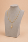 Elara gold teardrop layered necklace displayed on a jewellery bust
