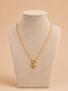 Gold heart pendant toggle necklace displayed on a cream jewellery bust