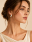 Model wearing Ivory Riviera gold-plated white enamel hoop earrings