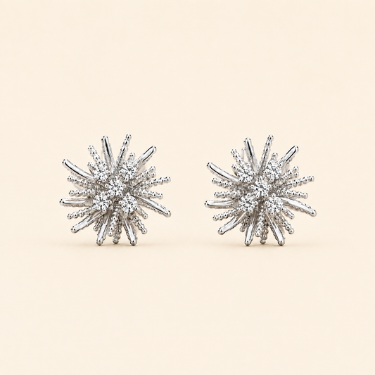 Lumière silver crystal burst stud earrings on soft ivory cream background