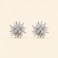 Lumière silver crystal burst stud earrings on soft ivory cream background