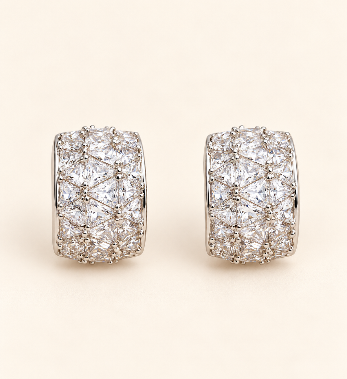 Milan Crystal Huggie Earrings with multi-cut crystals on soft ivory cream background