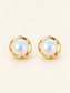 Pearl Glow gold-tone pearl stud earrings on a soft ivory cream background.