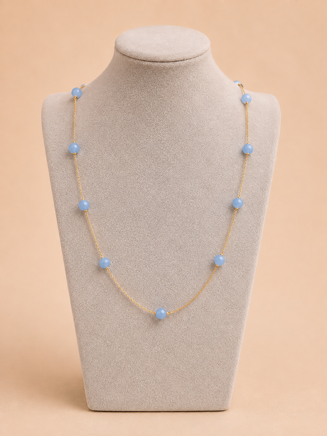 Serena blue beaded gold necklace displayed on a jewellery mannequin