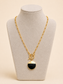 Noir Signet 18K gold-plated pendant necklace showing paperclip chain and adjustable fastening