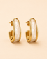 Ivory marble and gold sculpted hoop earrings on soft ivory cream background.