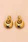 Front view of Valoria London Aurelia sculpted gold drop earrings with polished interlocking circular design