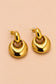 Three-quarter view of Valoria London Aurelia polished gold statement earrings with sculptural drop design