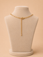 Back view of a gold paperclip necklace with lobster clasp and extender chain on a cream jewellery mannequin