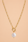 Valoria London Elara gold toggle necklace with an irregular pearl-effect pendant displayed against a soft peach background