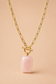 Valoria London gold paperclip chain necklace with toggle clasp and pink rectangular stone pendant, front view on jewellery display