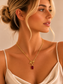 Valoria London Ruby Radiance gold paperclip chain necklace with emerald-cut ruby-red crystal pendant and signature toggle clasp.